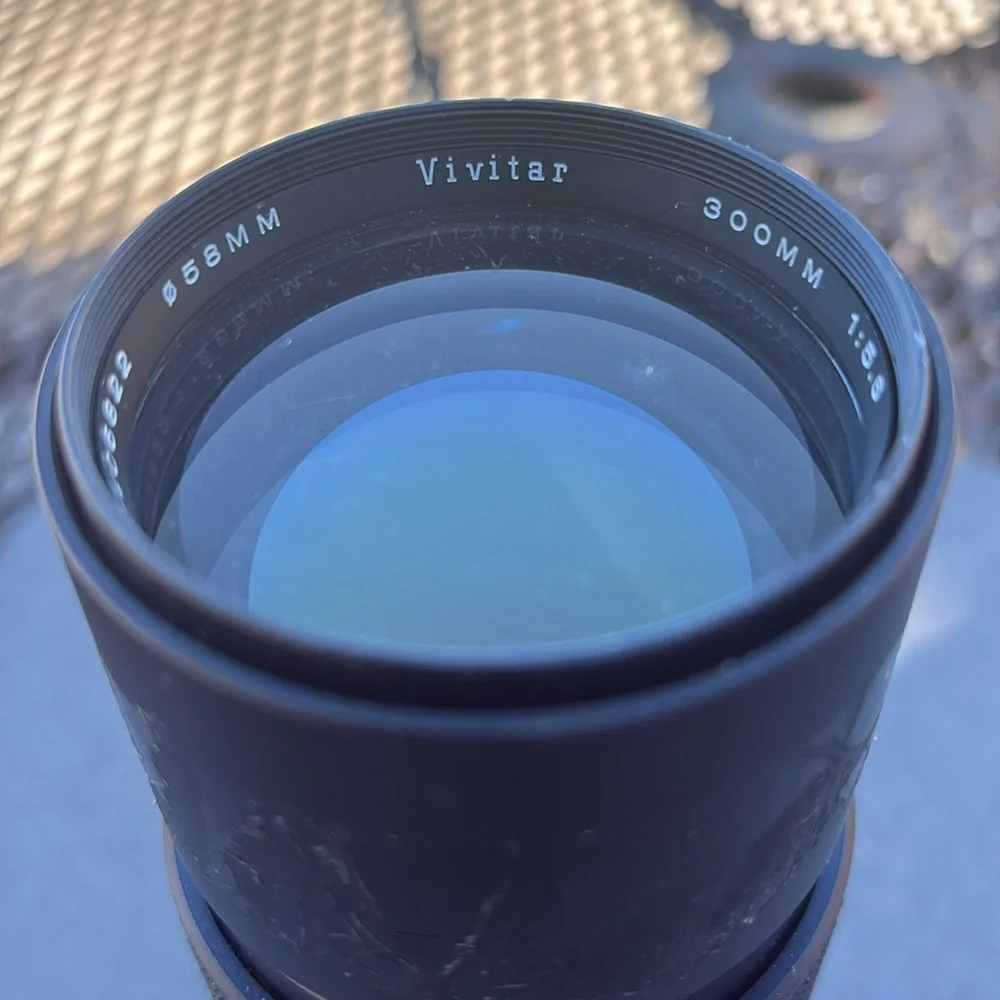 The image shows a Vivitar 300mm 1:5.6 lens. Additional information: